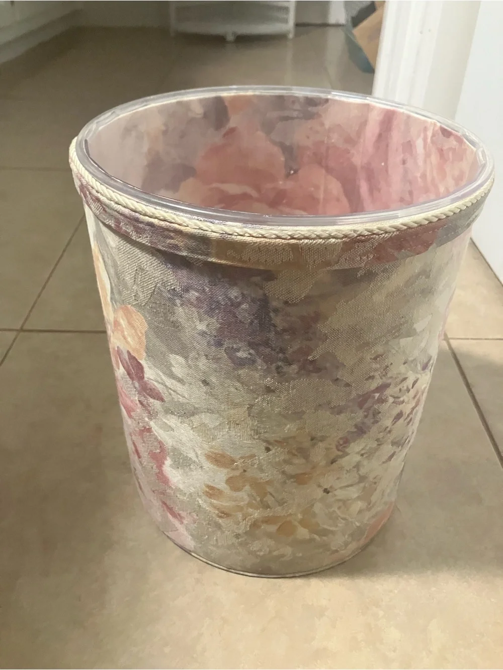 2 vintage floral tapestry fabric wastebaskets with plastic liners in them